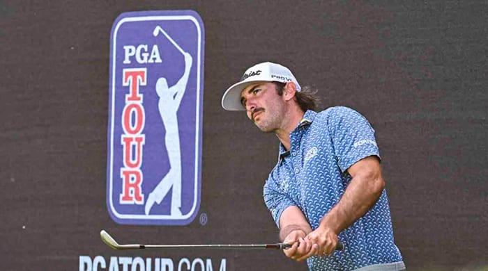 Max Homa chips a shot next to PGA Tour signage during the 2022 Arnold Palmer Invitational presented by MasterCard at Bay Hill Club and Lodge in Orlando, Fla.